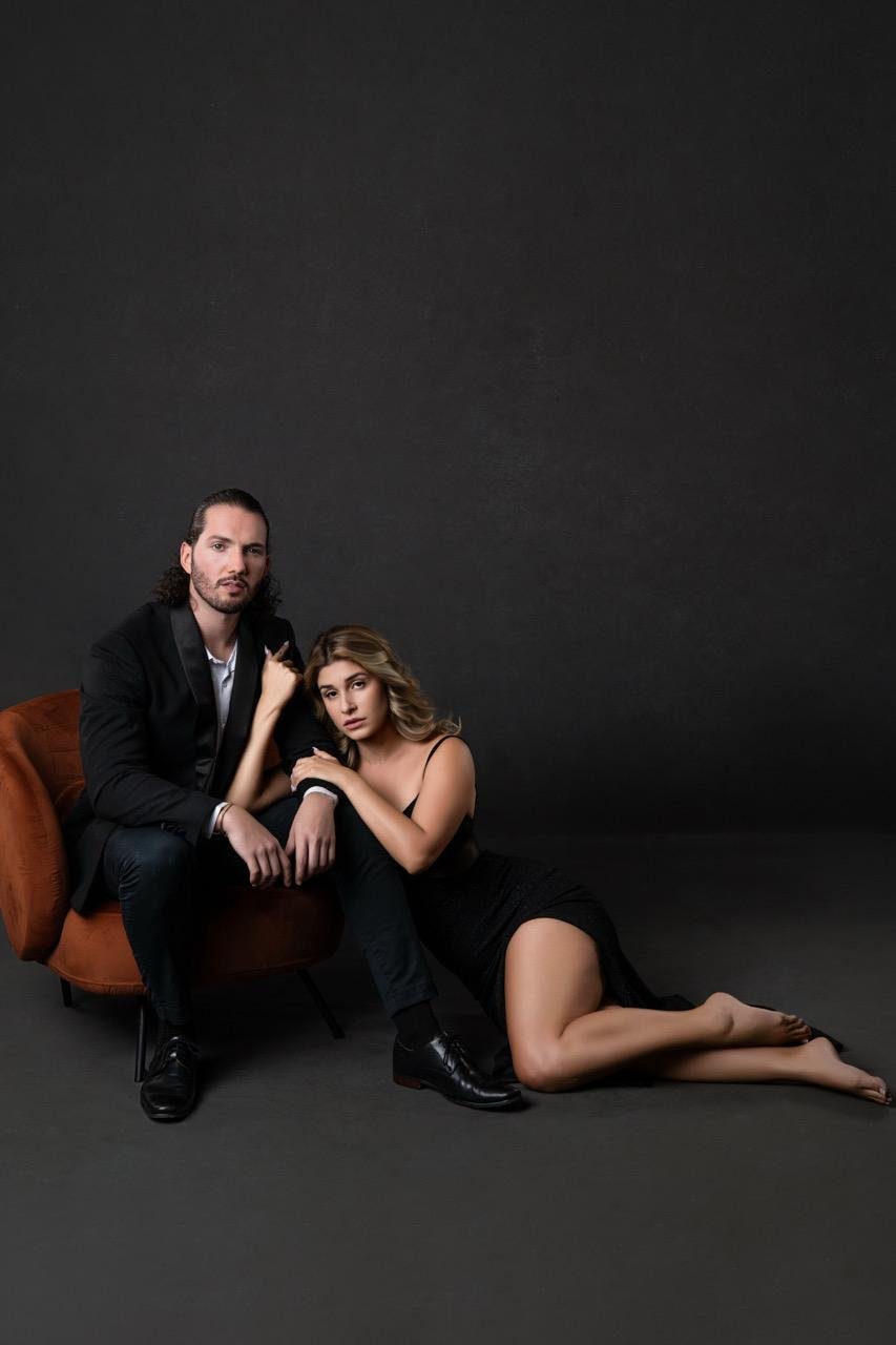 Styled couples boudoir portrait in a dark studio